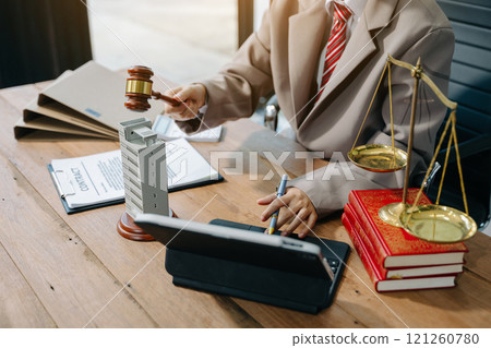 Real Estate Lawyer And House Foreclosure Law. House model, hammer judge gavel on table with white background. Foreclosure, bankruptcy concept 121260780