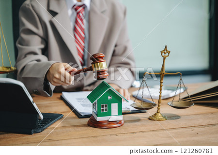 Real Estate Lawyer And House Foreclosure Law. House model, hammer judge gavel on table with white background. Foreclosure, bankruptcy concept 121260781