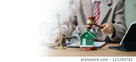 Real Estate Lawyer And House Foreclosure Law. House model, hammer judge gavel on table with white background. Foreclosure, bankruptcy concept 121260782
