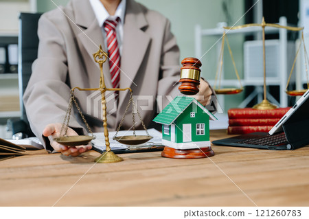 Real Estate Lawyer And House Foreclosure Law. House model, hammer judge gavel on table with white background. Foreclosure, bankruptcy concept 121260783