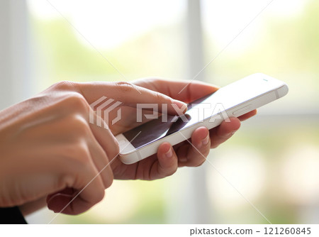 Hands touching and operating a smartphone screen Hands touching and operating a smartphone screen 121260845
