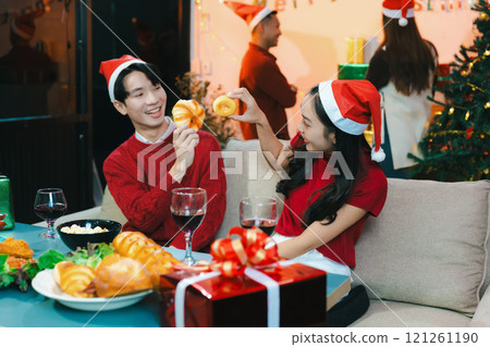 drinks and conversation, people celebrating together at Merry Christmas and Happy New Year. Friends are happy and celebrating with food, wine and friendship of love and gift exchange at the event. drinks and conversation, people celebrating together at Merry Christmas and Happy New Year. Friends are happy and celebrating with food, wine and friendship of love and gift exchange at the event. 121261190