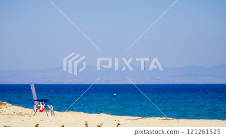 Deck chair on beach Deck chair on beach 121261525