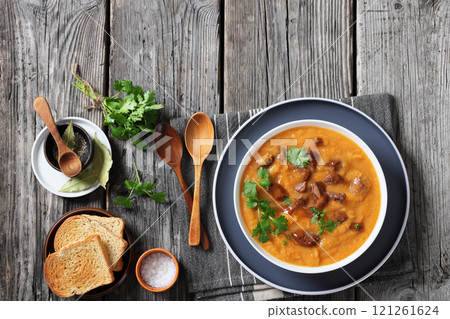 creamy carrot beef soup in a white bowl 121261624
