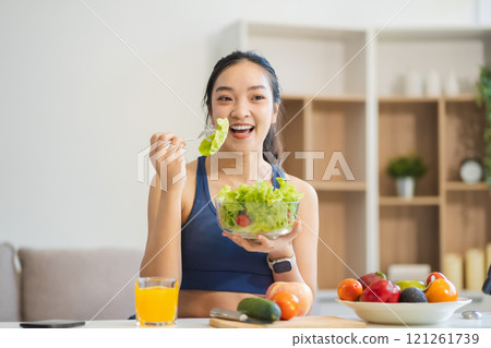 Fit woman enjoys healthy fruit breakfast, healthy lifestyle. 121261739