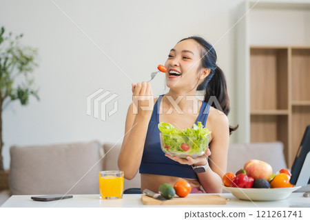 Fit woman enjoys healthy fruit breakfast, healthy lifestyle. 121261741