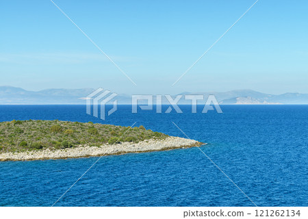 Greek coastline next to sea shore during warm weather. 121262134