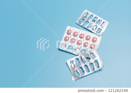 Empty and used medicine blister packs with pink pills. Empty and used medicine blister packs with pink pills. 121262240