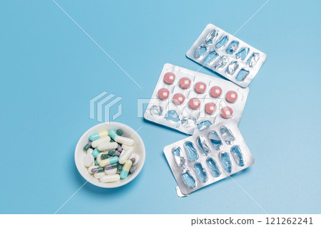 Empty and used medicine blister packs with pink pills. Empty and used medicine blister packs with pink pills. 121262241