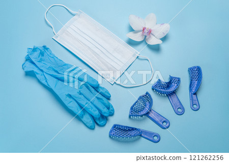 Latex gloves, a medical mask and dental pliant impression trays. Latex gloves, a medical mask and dental pliant impression trays. 121262256