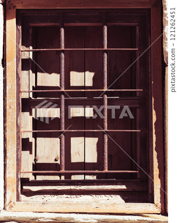 Old rustic window with grilles 121262451