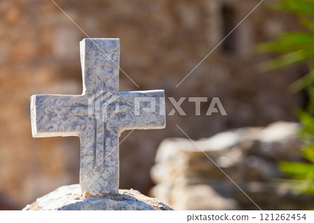Greek stone cross on burial ground 121262454
