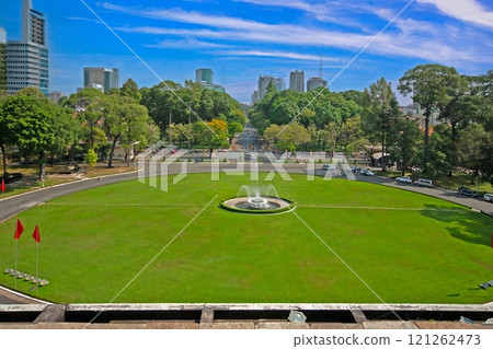 View of Reunification Palace park with fountain and greenery in Ho Chi Minh City, Vietnam View of Reunification Palace park with fountain and greenery in Ho Chi Minh City, Vietnam 121262473