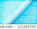 A macro photograph showcasing the intricate texture of a blue feather, revealing fine barbs and a central rachis 121262593