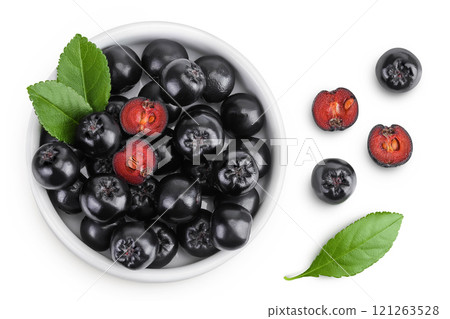 Chokeberry with leaf in a ceramic bowl isolated on white background. Black aronia. Top view. Flat lay Chokeberry with leaf in a ceramic bowl isolated on white background. Black aronia. Top view. Flat lay 121263528