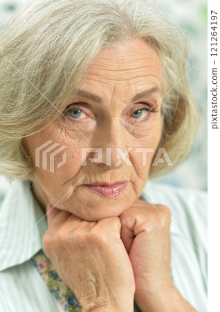Portrait of a sad elderly woman posing at home 121264197