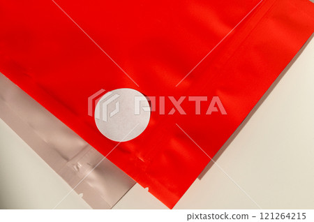 Red packaging bag with white sticker on surface Red packaging bag with white sticker on surface 121264215