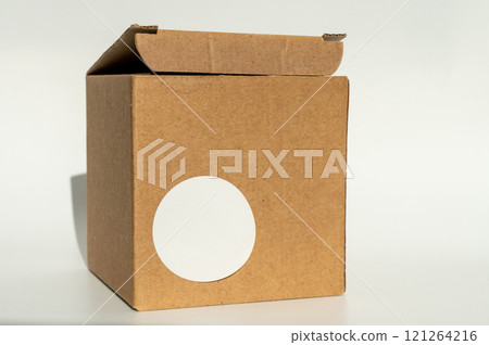 National Cartonnage Day. Cardboard box with white round sticker. Minimal product packaging design National Cartonnage Day. Cardboard box with white round sticker. Minimal product packaging design 121264216