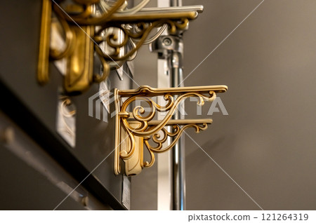 Decorative metal shelf brackets in various styles on display. Decorative metal shelf brackets in various styles on display. 121264319