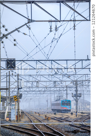 Chichibu Station and Deha 7500 series train in the foggy early morning in Chichibu City, Saitama Prefecture 121264670