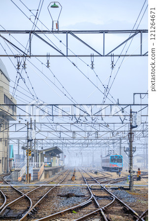 Chichibu Station and Deha 7500 series train in the foggy early morning in Chichibu City, Saitama Prefecture 121264671