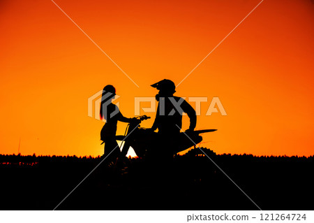 Silhouette of a girl and a man on a motorcycle. Silhouette of a girl and a man on a motorcycle. 121264724