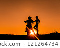 Silhouette of a girl and a man on a motorcycle.  121264734
