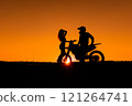 Silhouette of a girl and a man on a motorcycle.  121264741