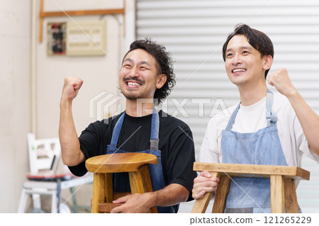 Men making DIY chairs (fist pump) Men making DIY chairs (fist pump) 121265229