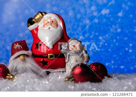 Ceramic Santa Claus statue ,snowman ,gnome figure, christmas tree toys standing on snow  121266471