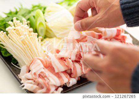 A man preparing ingredients for shabu-shabu A man preparing ingredients for shabu-shabu 121267265