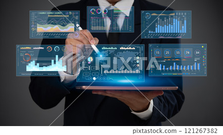 Businessman analyzing financial data on tablet with futuristic digital dashboard and visual analytics Businessman analyzing financial data on tablet with futuristic digital dashboard and visual analytics 121267382