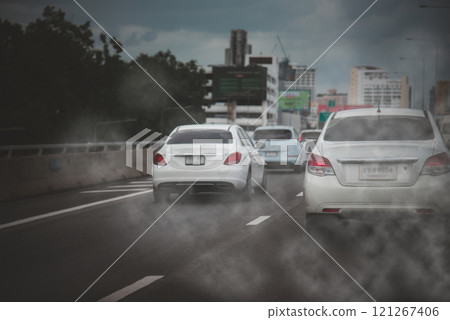 Cars emitting exhaust fumes on highway during heavy traffic in urban area Cars emitting exhaust fumes on highway during heavy traffic in urban area 121267406