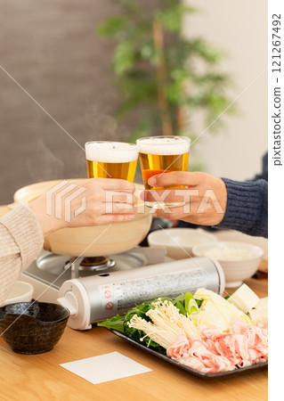 A middle-aged couple enjoying pork shabu-shabu hotpot 121267492