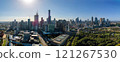 A panoramic view of a modern city skyline with tall skyscrapers, green parks, and urban architecture 121267530