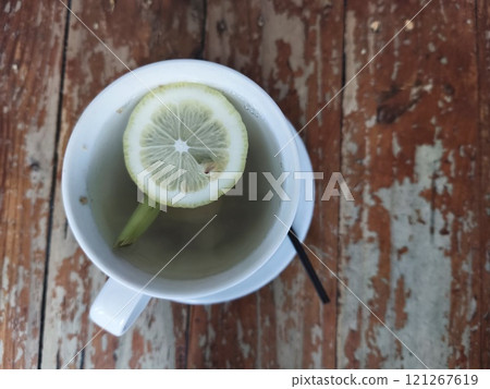 A steaming cup of hot lemon water, garnished with a lemon slice. A steaming cup of hot lemon water, garnished with a lemon slice. 121267619