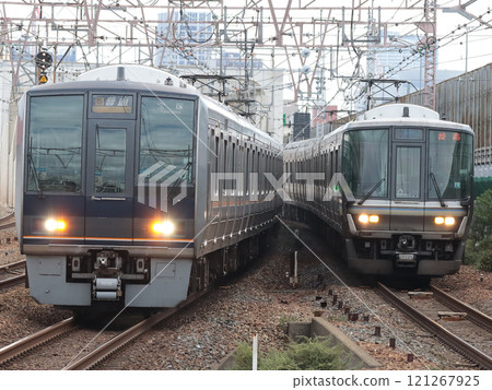 A battle between a 207 series ordinary train bound for Takarazuka (S17) and a 223 series special rapid service train bound for Himeji (W9) 121267925