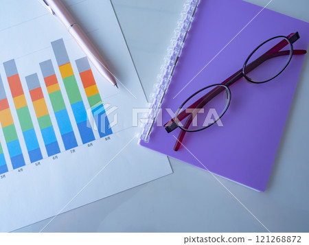 Graph, notebook and glasses on the table Graph, notebook and glasses on the table 121268872