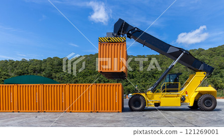 Reach stacker cargo forklift container box import export logistic transportation industrial, Reach stacker pick up container, Reach stacker container loader crane lifting maritime cargo container. 121269001