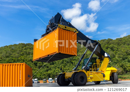 Reach stacker cargo forklift container box import export logistic transportation industrial, Reach stacker pick up container, Reach stacker container loader crane lifting maritime cargo container. Reach stacker cargo forklift container box import export logistic transportation industrial, Reach stacker pick up container, Reach stacker container loader crane lifting maritime cargo container. 121269017