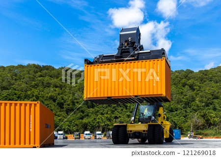 Reach stacker cargo forklift container box import export logistic transportation industrial, Reach stacker pick up container, Reach stacker container loader crane lifting maritime cargo container. 121269018