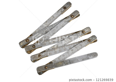 Antique carpenter's brass ruler isolated on white. 121269839