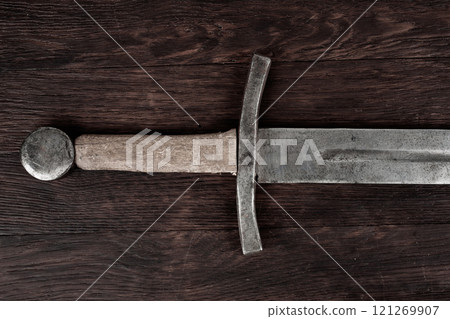 Medieval sword on wooden backgrond. Medieval sword on wooden backgrond. 121269907