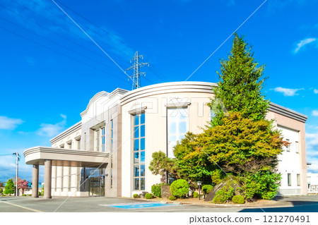 Family Hall shining against the blue sky (image of a funeral hall) 121270491