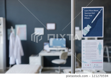 Minimal background image of medical clinic interior with focus on vaccine information poster on glass wall, computer desk in blurred background, copy space Minimal background image of medical clinic interior with focus on vaccine information poster on glass wall, computer desk in blurred background, copy space 121270594