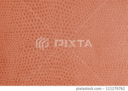 Cloth structure of  jacquard orange fabric with abstract shabby spotted texture closeup, macro 121270762