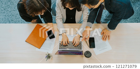 Three businessmen having a meeting using a laptop 121271079