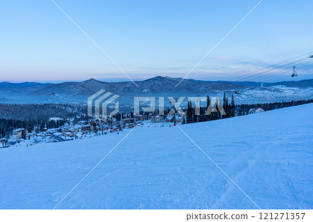 evening at the ski resort, empty ski lift and slope 121271357