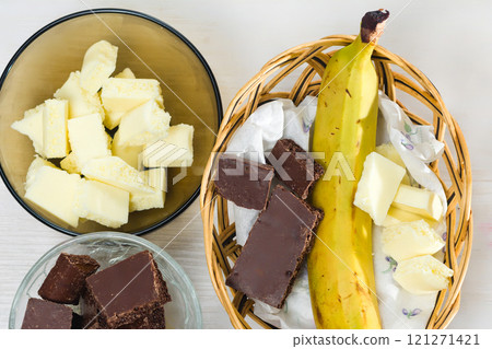 Ingredients for dessert: banana, dark and white chocolate Ingredients for dessert: banana, dark and white chocolate 121271421