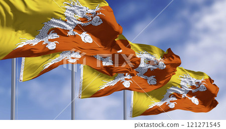 Close-up of two Bhutan national flags waving in the wind. 121271545